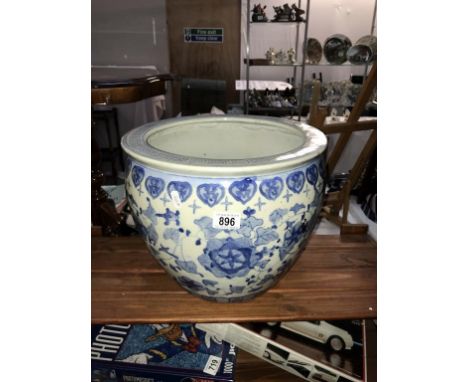 A large blue and white planter (cracks to base).