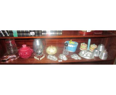 A mixed lot of kitchenalia including jelly moulds, sugar sifter, vintage cookie cutters etc.,