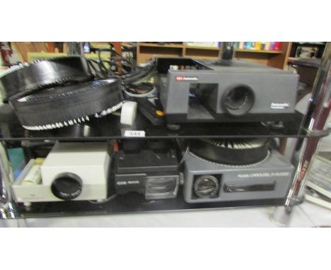 A Kodak slide projector and three others.  (Collect only)