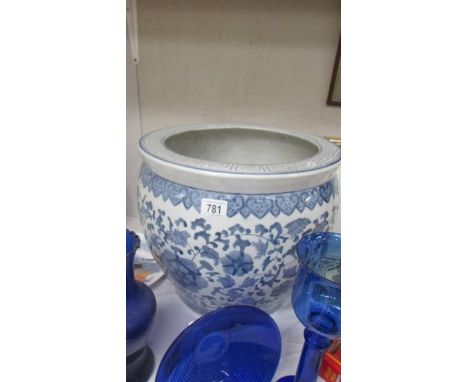 A large blue and white planter (cracks to base).