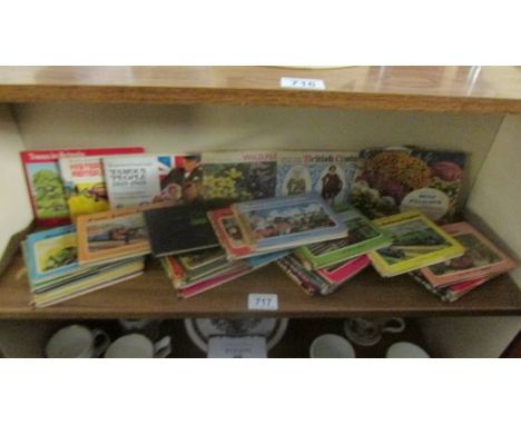 Approximately 24 early Thomas The Tank Engine books and six books of tea cards.