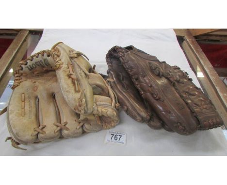 Two vintage baseball mitten gloves by Spalding &amp; Wilson.