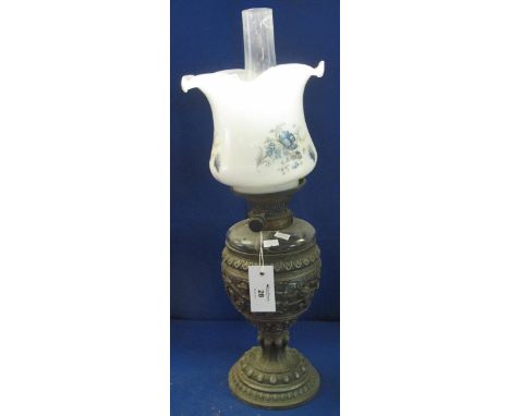Early 20th Century brass double burner oil lamp, having glass reservoir in goblet shaped relief spelter base with floral prin