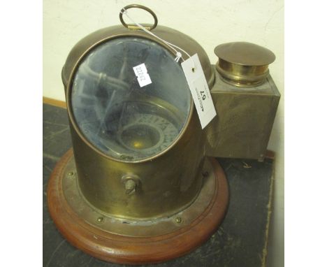 Small brass ship's binnacle with gimballed card compass, on wooden base.(B.P. 24% incl. VAT)   CONDITION REPORT:  Bottom bras