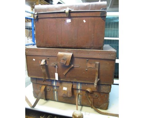 Two vintage leather suitcases with various labels, together with a vintage tin trunk. (3)(B.P. 24% incl. VAT)