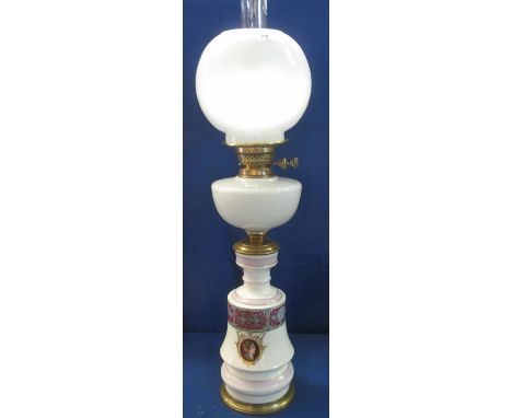 Early 20th Century brass double burner oil lamp having opaline glass reservoir on a ceramic Classically printed pedestal base