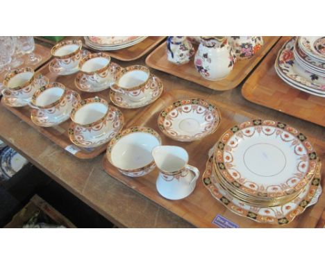 Two trays of Royal Albert Crown china teaware on a white ground with swag and foliate decoration, comprising: teacups and sau