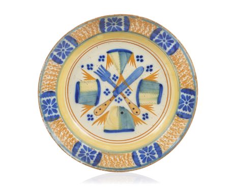 A Portuguese faience dish "Cutlery and fish fillets"Portuguese faienceAttributable to BandeiraPolychrome decoration depicting