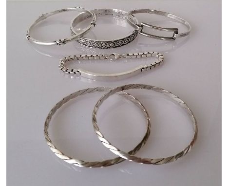 Six Tiffany &amp; Co. sterling silver bangles: two swirl, one with knot design, one with oblong panel dated 2003, a bracelet 