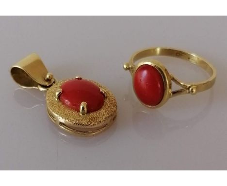 An Italian oval coral pendant on a textured gold mount, the cabochon coral measuring 10mm x 8mmm and a similar ring, the cabo