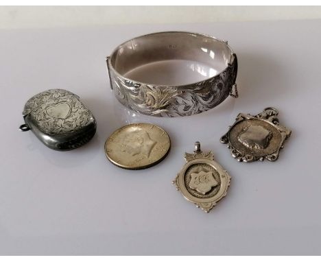 An Edwardian Birmingham silver vesta case, 1907; a silver cuff bangle by Lawson, Ward &amp; Gammage Ltd, London, 1973, both w