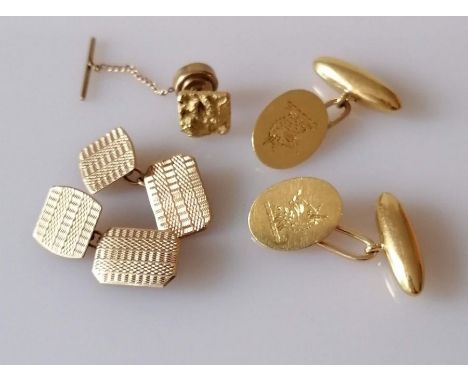 A pair of 18ct gold oval cufflinks with etched heraldic emblem, 9.8g and a pair of 9ct rose gold cufflinks with engine turned