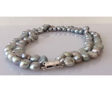 A two-row Tahitian pearl necklace comprising eighty-six baroque beads, measuring between 8-11mm, strung without knots on a wh