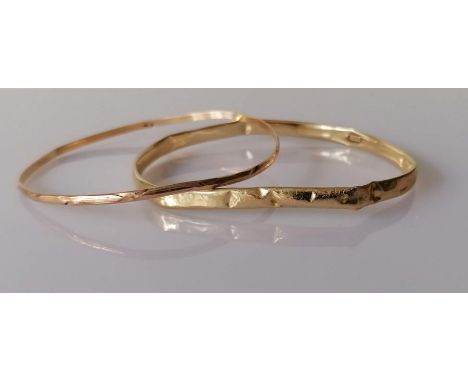 A yellow gold bangle, stamped 14k for Michael Anthony, New York, 6.1g and another with indistinct hallmarks, testing for 18ct