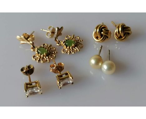Two pairs of Tiffany &amp; Co. stud earrings: one yellow gold love-knot design, the other pearl, both signed and stamped 750,