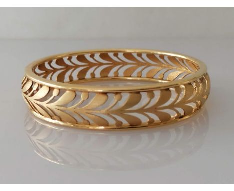 A yellow gold pierced bangle, unmarked, tests for 18ct, 44.6g
