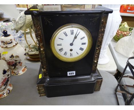 An ornamental slate mantel clock with enameled dial