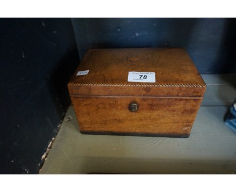 A Georgian inlaid mahogany tea caddy of rectangular form complete with interior works.