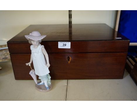 An Edwardian mahogany writing slope, together with a Nao figure of a girl holding a parasol.