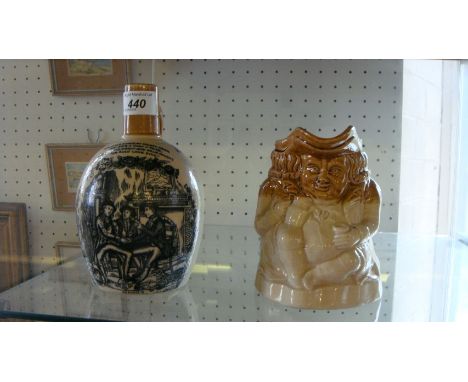 An Olde Lang Syne advertising scotch whisky jug together with a twin tone Toby jug.