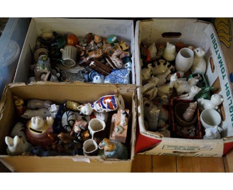 A mixed lot of assorted ceramic animals to include Wade Whimsies, crested ware etc.