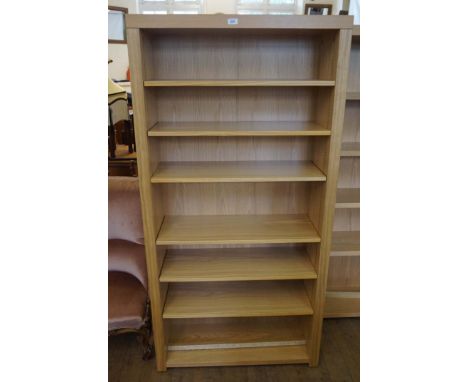 A contemporary light oak finished freestanding bookcase having six adjustable shelves.
