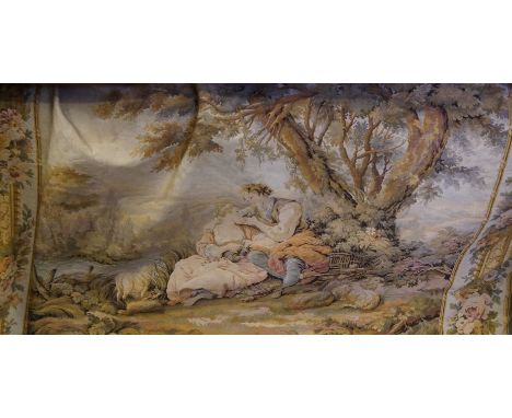 A vintage hanging tapestry panel depicting figures in landscape.