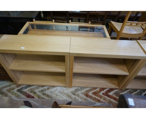 A pair of dwarf light oak finished bookcase each having single adjustable shelves.