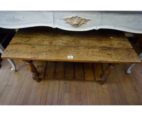 A good quality reproduction solid oak plank top coffee table with magazine under shelf.