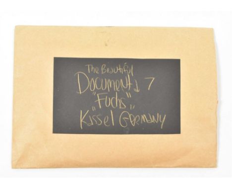 Cardboard envelope, 28 x 20 cm, with mounted black card addressed in gold handwriting to 'The Beautiful Documenta 7 'Fuchs' K