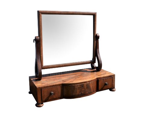 A mahogany toilet mirror, 19th Century, with a square plate above a central bow front with drawer, flanked by two smaller dra