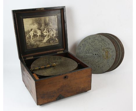 Polyphon music box, 19th Century, the inside inset with a printed scene of cherubs, the movement 4 3/4 in wide, with eighteen
