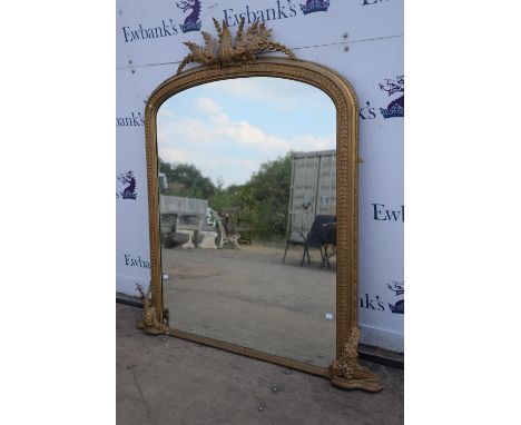 A gilt framed over mantle mirror.