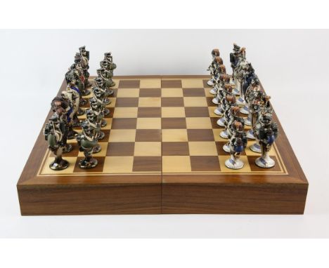 A pottery chess set, 20th Century, the pieces made up of Russian and Napoleonic soldiers, the King 16cm high, in a wooden che