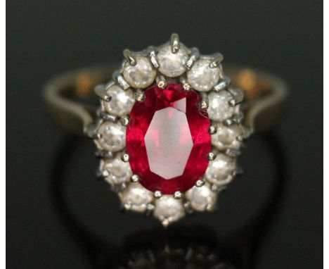 A synthetic ruby and cubic zirconia cluster ring, band marked '585', gross wt. 2.95g, size M.  Condition - good, general wear