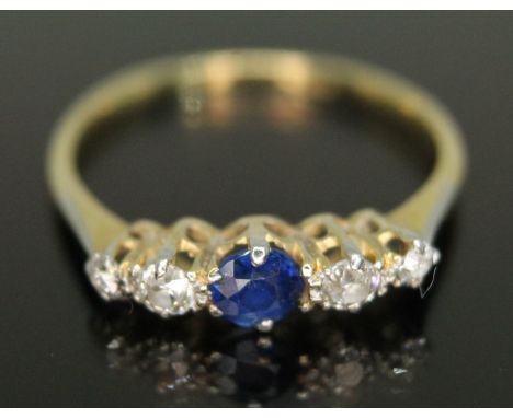 A five stone diamond and sapphire ring, the central stone weighing approx. 0.20 carats, total diamond wt. approx. 0.30 carats