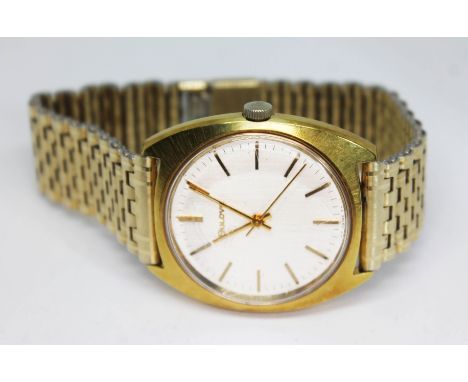 A 1960s gold plated Bulova wristwatch having signed silvered dial with gold tone hour markers and hands, 35mm case with stain