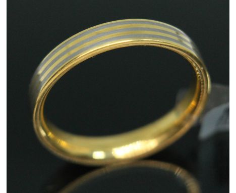 A yellow metal and titanium wedding band by Feniom, inverted D-section with alternate bands to outer edge, marked 'AU750', gr