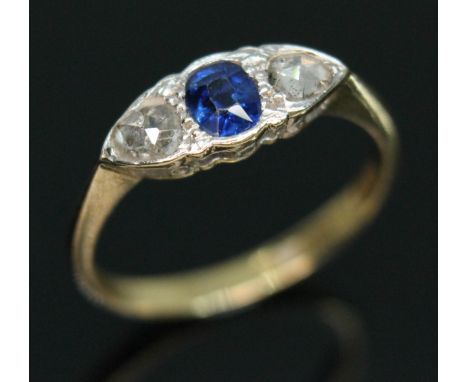 A diamond and sapphire ring, the central oval mixed cut sapphire weighing approx. 0.42 carats, set between two pear shaped ro