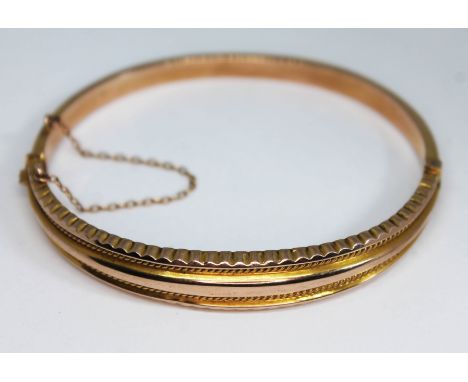 A 9ct rose gold bangle, sponsors mark 'S&amp;P', Birmingham, date letter 'O', diam. 58mm, wt. 6.91g.  