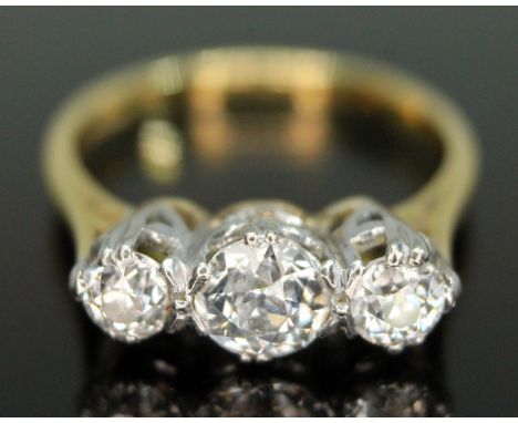 A three stone diamond ring, the Old European cut diamonds weighing approx. 0.30, 0.72 &amp; 0.33 carats, hallmarked 18ct gold