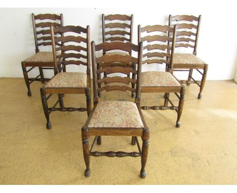 Six oak ladder back chairs