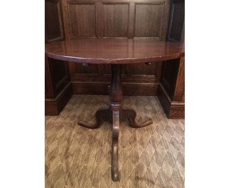 A Victorian oak tripod tea table