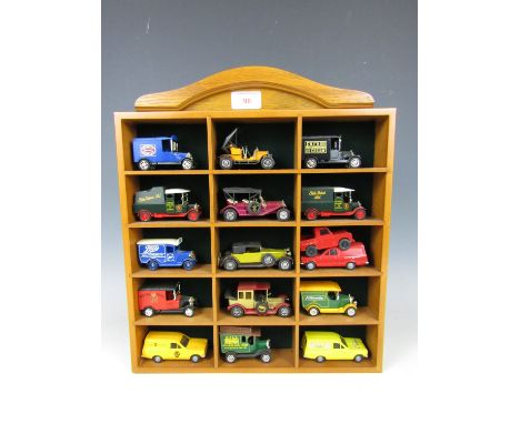 Sixteen model cars and vans together with display stand