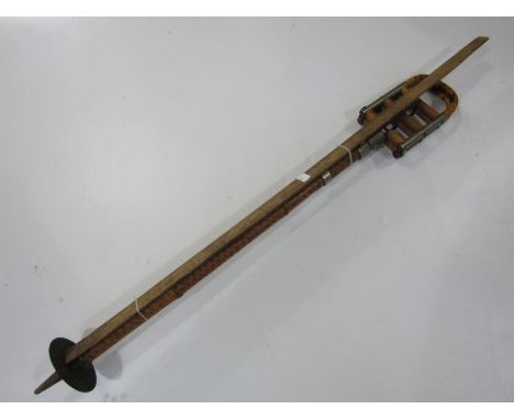 A vintage cane shooting stick together with an advertising yard stick