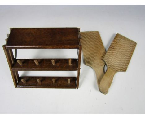 An inter-War wooden folding sewing bobbin stand together with a pair of treen butter pats