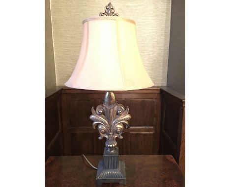 An antiqued gilt table lamp