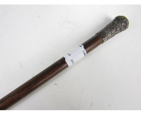 A swagger stick with white metal pommel