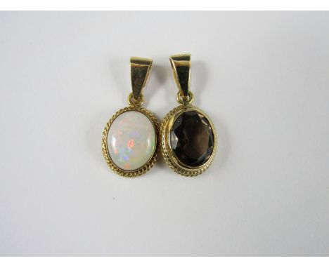 Two modern 9ct gold pendants, rub and rope set with a cabochon opal and quartz respectively