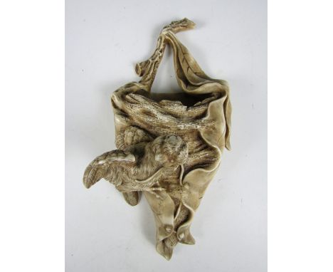 A late 19th Century ceramic wall pocket in the form of a mother bird attending her nest (a/f)